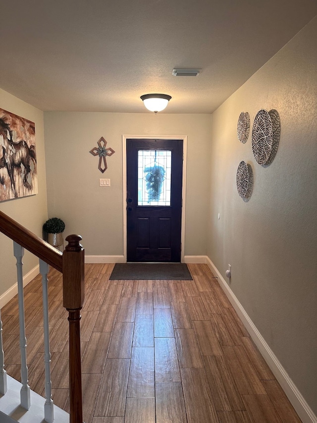 entryway with wood-type flooring