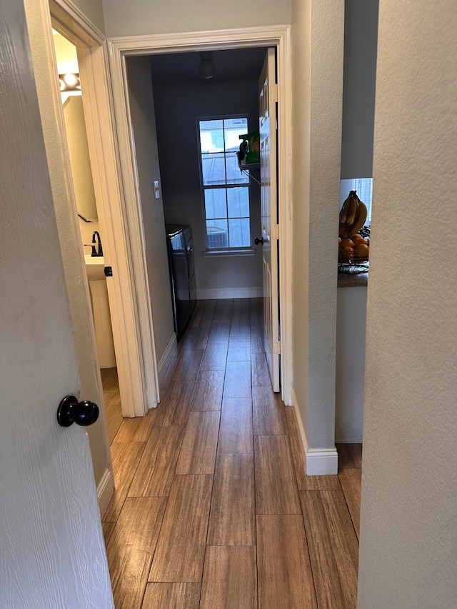 hallway with hardwood / wood-style floors