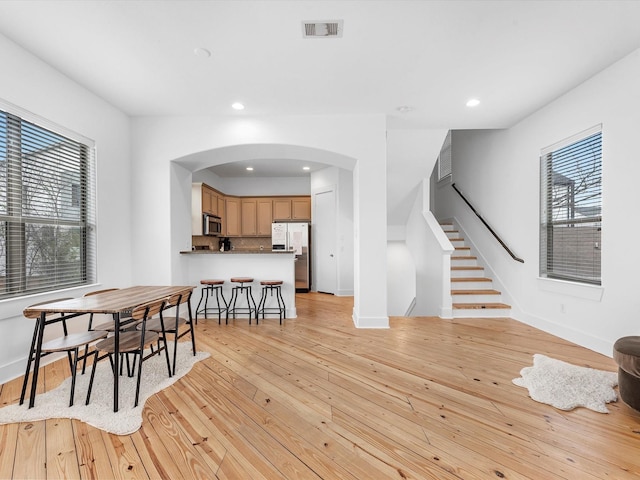 dining space with plenty of natural light and light hardwood / wood-style floors