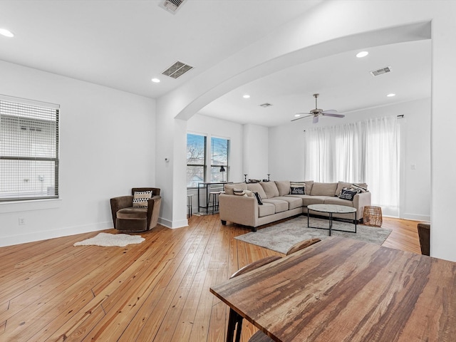 living room featuring ceiling fan and light hardwood / wood-style flooring