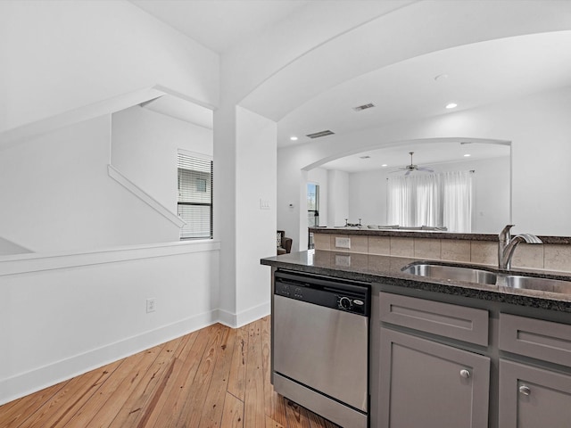 kitchen with light wood-type flooring, stainless steel dishwasher, ceiling fan, sink, and gray cabinets