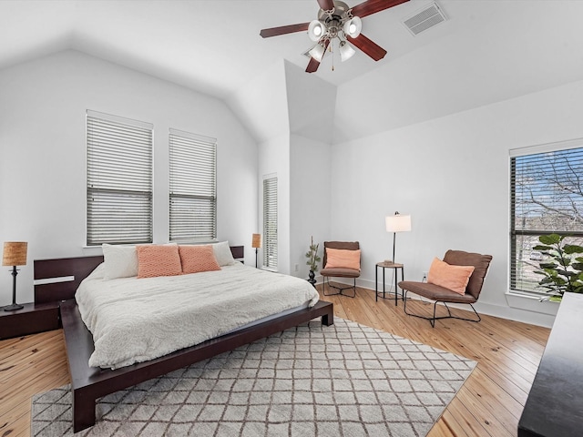 bedroom featuring ceiling fan, light hardwood / wood-style flooring, and lofted ceiling