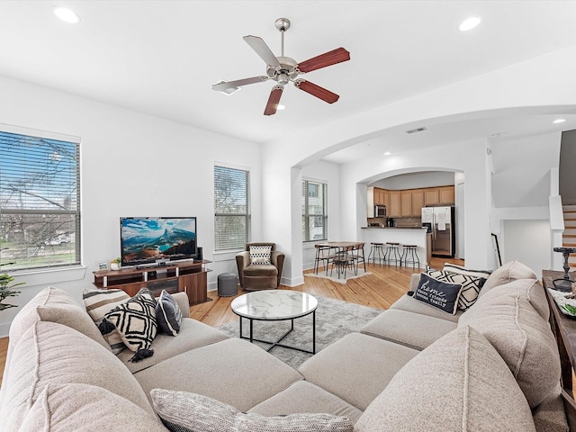 living room with ceiling fan and light hardwood / wood-style floors