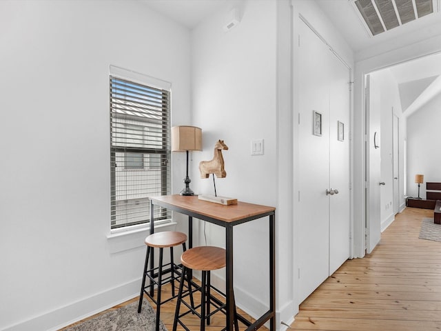 hallway with light hardwood / wood-style floors