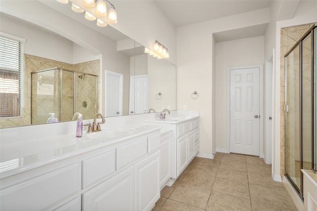 bathroom with tile patterned floors, vanity, and a shower with shower door