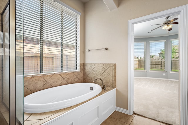 bathroom featuring tile patterned flooring, a bathtub, ceiling fan, and ornamental molding