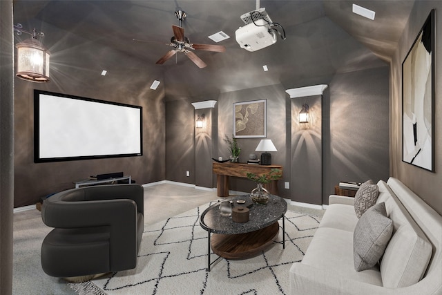 carpeted cinema featuring ceiling fan and vaulted ceiling