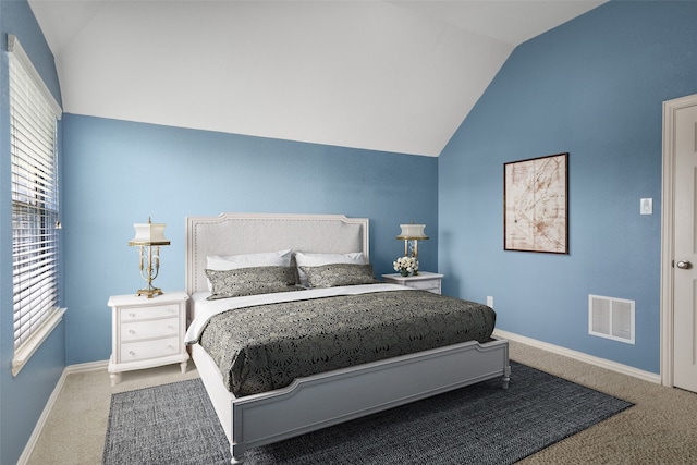 carpeted bedroom with vaulted ceiling