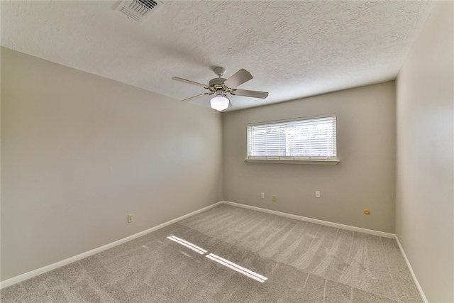 carpeted empty room featuring a textured ceiling and ceiling fan