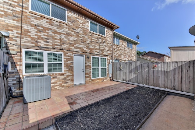 back of property featuring central AC and a patio