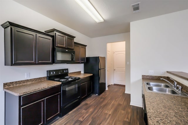 kitchen featuring sink, black appliances, and dark hardwood / wood-style floors