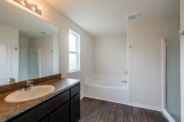 bathroom with vanity, wood-type flooring, and independent shower and bath