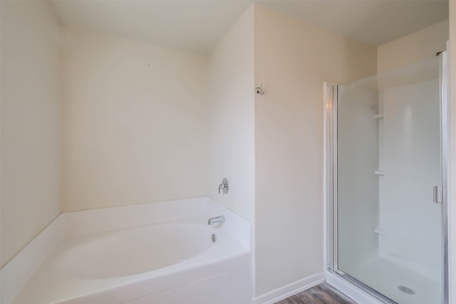 bathroom with separate shower and tub and wood-type flooring