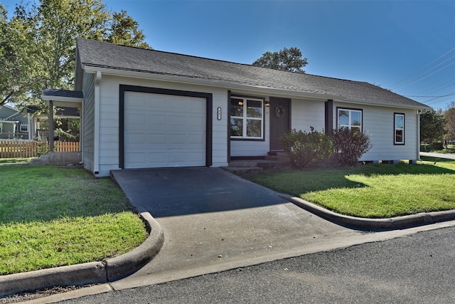 ranch-style home with a garage and a front lawn