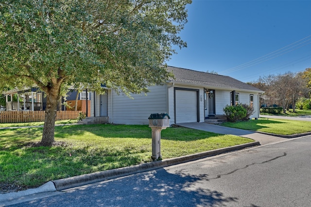 single story home featuring a front yard and a garage