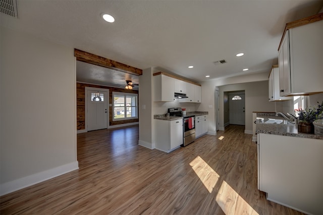 kitchen with light stone counters, ceiling fan, white cabinets, light hardwood / wood-style floors, and stainless steel electric range