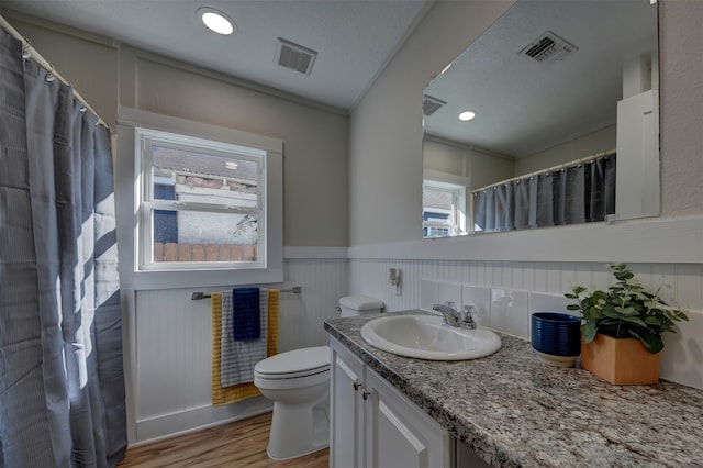 bathroom with hardwood / wood-style floors, vanity, and toilet