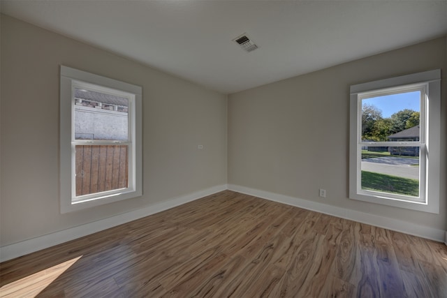 unfurnished room featuring hardwood / wood-style floors