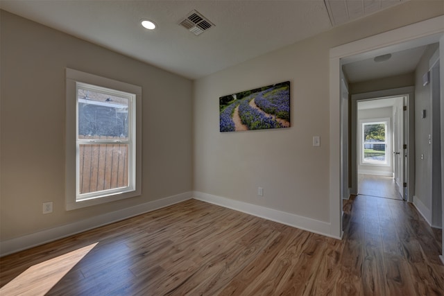 spare room featuring wood-type flooring