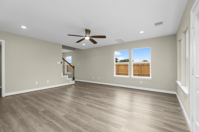 unfurnished living room with ceiling fan and light hardwood / wood-style flooring