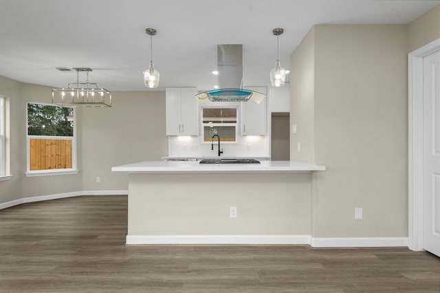 kitchen with decorative light fixtures, white cabinetry, island exhaust hood, and dark wood-type flooring