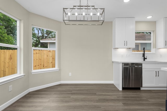 unfurnished dining area featuring sink, dark hardwood / wood-style floors, and a notable chandelier