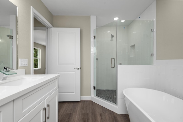 bathroom featuring vanity, separate shower and tub, and wood-type flooring