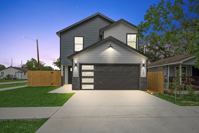 view of front facade with a lawn and a garage