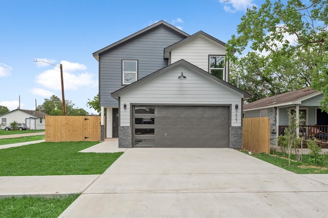 view of front of home featuring a front yard and a garage