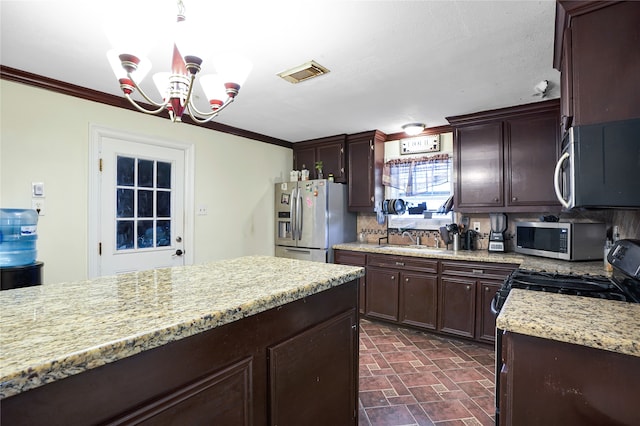 kitchen with crown molding, sink, appliances with stainless steel finishes, tasteful backsplash, and a notable chandelier