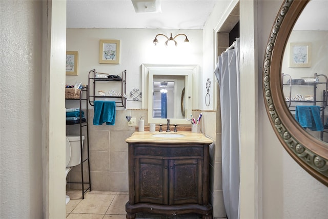 bathroom featuring tile patterned floors, vanity, and tile walls