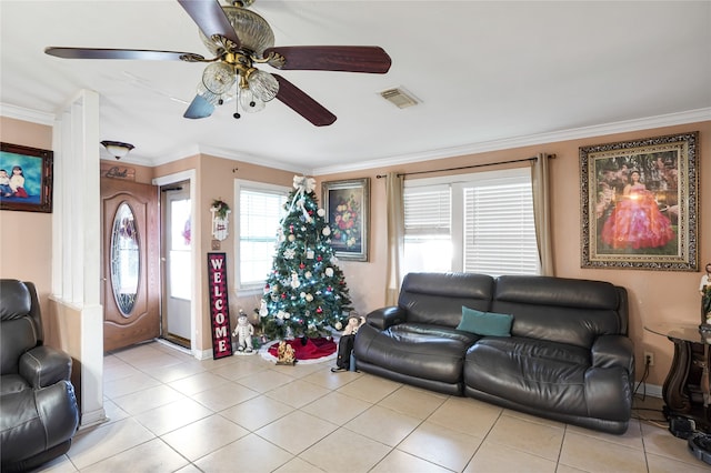 living room with crown molding, light tile patterned floors, and ceiling fan