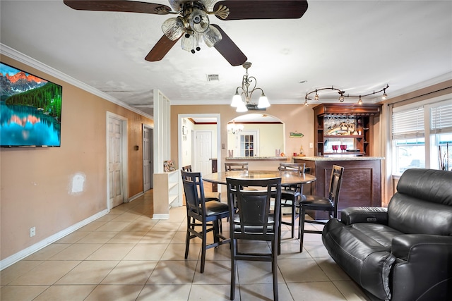 dining area with light tile patterned floors, ceiling fan with notable chandelier, and crown molding