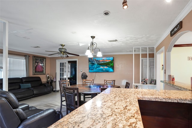 kitchen featuring ceiling fan with notable chandelier and crown molding