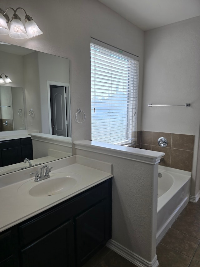 bathroom featuring a tub, tile patterned flooring, and vanity