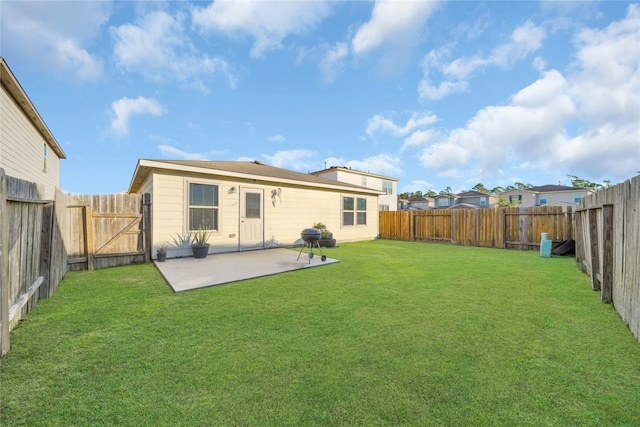 rear view of house featuring a patio and a lawn