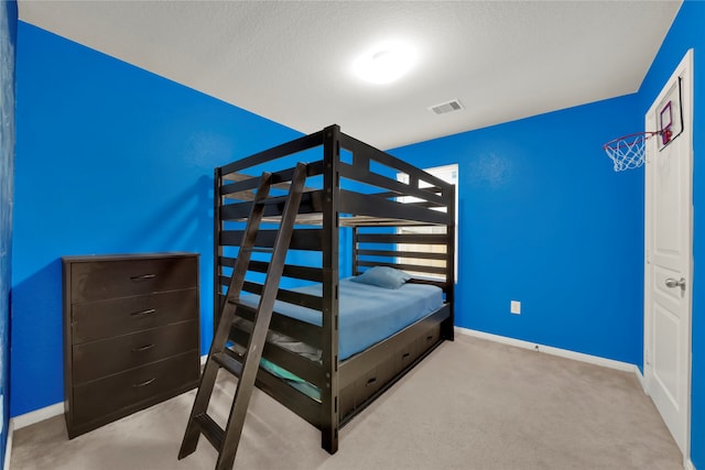 unfurnished bedroom with light colored carpet and a textured ceiling