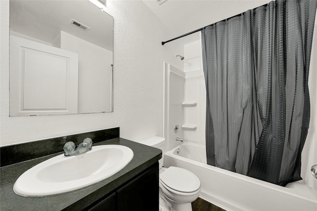 full bathroom featuring vanity, shower / bath combination with curtain, and toilet