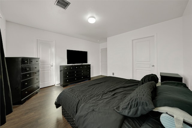 bedroom with dark hardwood / wood-style flooring