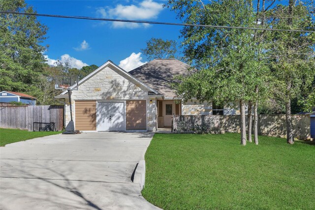 12466 Royal Lake Dr, Conroe, TX 77303 - view of front of home featuring stone siding, driveway, a front yard, and fence