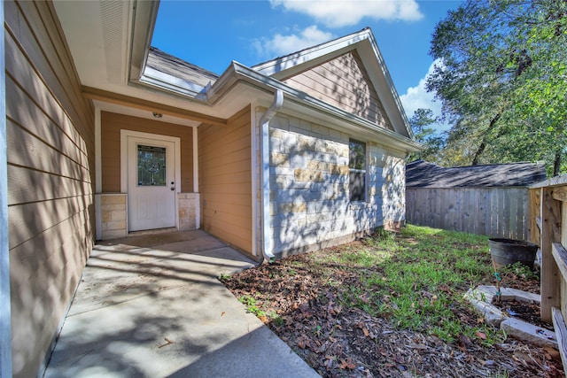 view of exterior entry with a patio