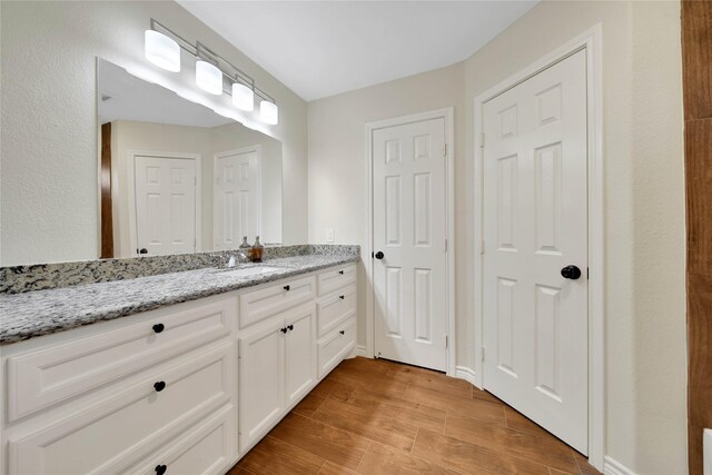 bathroom featuring vanity and wood-type flooring