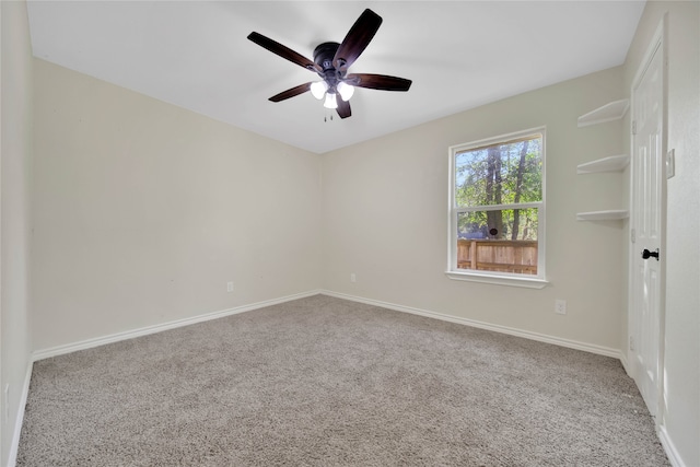 carpeted spare room featuring ceiling fan