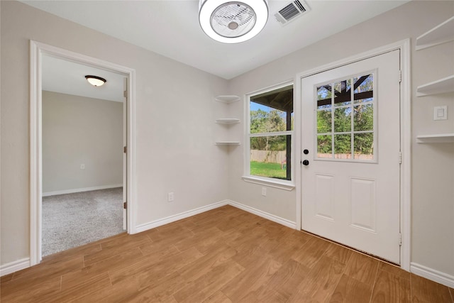 12466 Royal Lake Dr, Conroe, TX 77303 - doorway with light wood-style floors, visible vents, and baseboards