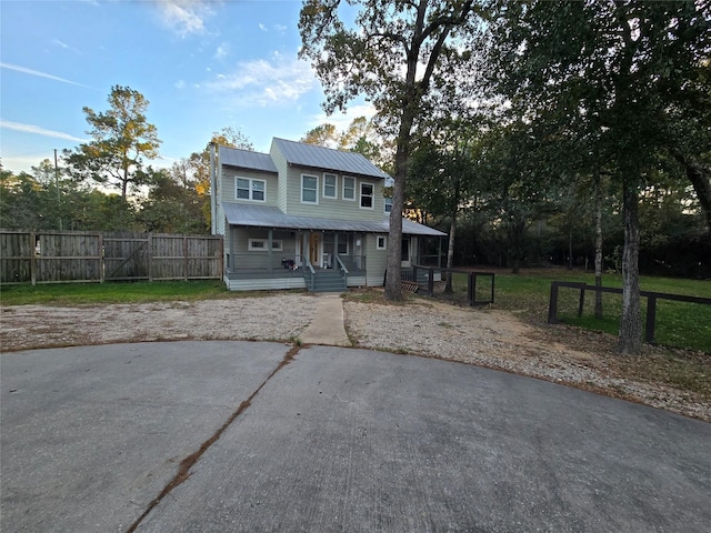 view of front of home featuring a front yard and a porch