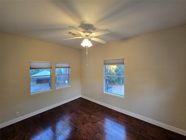 empty room featuring ceiling fan and dark hardwood / wood-style flooring