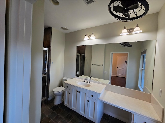 bathroom with vanity, toilet, and a shower with door