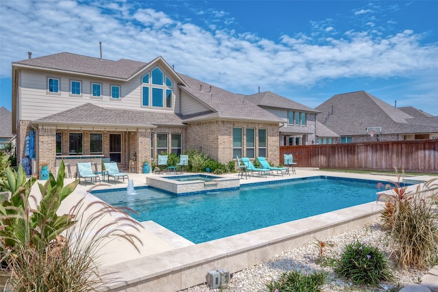 view of pool featuring a patio area and an in ground hot tub