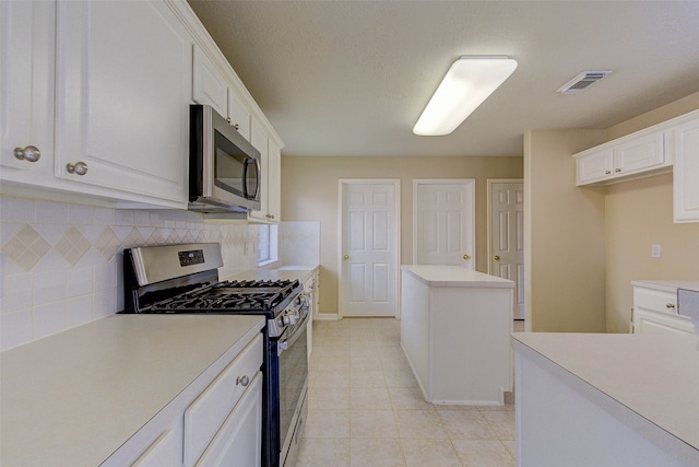 kitchen with backsplash, white cabinetry, a center island, and stainless steel appliances