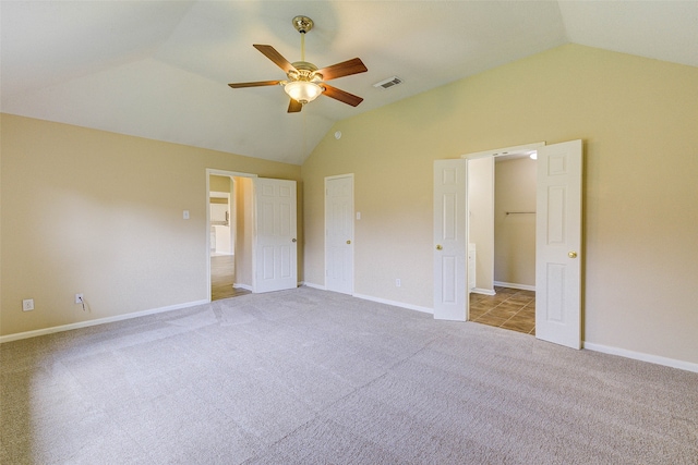 unfurnished bedroom featuring ceiling fan, light carpet, and vaulted ceiling